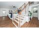 Elegant staircase with wood and white railings leading to an open living area at 105 Kirkhaven Ct, Goose Creek, SC 29445