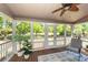 Relaxing sunroom featuring wood flooring, large windows with backyard views, and a ceiling fan at 105 Kirkhaven Ct, Goose Creek, SC 29445