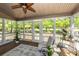 Relaxing sunroom featuring wood flooring, large windows with backyard views, and a ceiling fan at 105 Kirkhaven Ct, Goose Creek, SC 29445