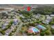 Aerial view of a community pool and tennis courts surrounded by beautiful homes, lush trees, and scenic waterways at 1104 Beresford Run, Charleston, SC 29492