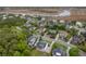 An aerial view shows homes in a marsh-front community with mature trees and well-maintained landscaping at 1104 Beresford Run, Charleston, SC 29492