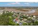 Aerial view of a beautiful neighborhood with mature trees, marshlands, and scenic waterways in the distance at 1104 Beresford Run, Charleston, SC 29492
