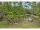 Scenic backyard with a pond view, featuring a custom-built treehouse for recreational enjoyment in a serene natural setting at 1104 Beresford Run, Charleston, SC 29492