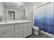 Bathroom featuring double sinks, white cabinets, and a tub with a blue shower curtain at 1104 Beresford Run, Charleston, SC 29492