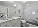 Modern bathroom features a walk-in shower with a bench, white subway tile and stone countertop at 1104 Beresford Run, Charleston, SC 29492