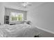 Bright bedroom with white walls, wood floors, and natural light from the large window at 1104 Beresford Run, Charleston, SC 29492