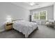 Well-lit bedroom with wood bed frame, white bedding, and natural light from large window at 1104 Beresford Run, Charleston, SC 29492