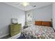 Bright bedroom with a ceiling fan, a large window, and a comfortable floral-patterned bed at 1104 Beresford Run, Charleston, SC 29492