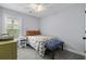 Bright bedroom with a ceiling fan, a large window, and a comfortable floral-patterned bed at 1104 Beresford Run, Charleston, SC 29492