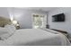 Bright bedroom features wooden bed frame, bedside tables, and a tv for a relaxing retreat at 1104 Beresford Run, Charleston, SC 29492