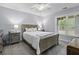 Well-lit bedroom features wooden bed frame, bedside tables, and plush carpeting for a comfortable space at 1104 Beresford Run, Charleston, SC 29492