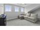 Cozy bonus room with gray walls, a sectional sofa, and natural light from three windows at 1104 Beresford Run, Charleston, SC 29492