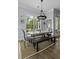 Charming dining space featuring natural light, table with chairs, a bench, and stylish light fixture at 1104 Beresford Run, Charleston, SC 29492