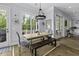 Bright dining area with views to outside features rustic table, chairs and bench seating at 1104 Beresford Run, Charleston, SC 29492