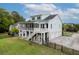 Expansive backyard view with outdoor patio, a large screened porch, a staircase to the fenced yard, and an attached garage at 1104 Beresford Run, Charleston, SC 29492