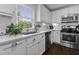 Well-lit kitchen features stainless appliances, white subway tile backsplash, quartz countertops, and open window at 1104 Beresford Run, Charleston, SC 29492
