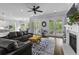Open-concept living area featuring dark sofa, hardwood floors, fireplace, and access to an outdoor space at 1104 Beresford Run, Charleston, SC 29492