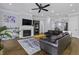 Inviting living room features a fireplace, dark sofas, wood floors, and a ceiling fan at 1104 Beresford Run, Charleston, SC 29492