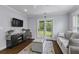 Bright living room with hardwood floors, comfortable seating, and sliding doors leading to outdoors at 1104 Beresford Run, Charleston, SC 29492
