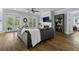 Bright living area features hardwood floors, dark sofa, fireplace, and access to an outdoor space at 1104 Beresford Run, Charleston, SC 29492
