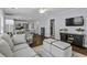 Bright open concept living room next to kitchen area with hardwood floors and comfortable seating at 1104 Beresford Run, Charleston, SC 29492