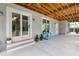 Covered patio with exposed wood ceiling, gray siding, a sliding glass door and a small table at 1104 Beresford Run, Charleston, SC 29492