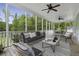 Inviting screened porch with stylish seating, ceiling fans, and picturesque views of the outdoors at 1104 Beresford Run, Charleston, SC 29492