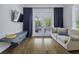 Sitting area features hardwood floors, a ceiling fan, TV, and patio access at 1104 Beresford Run, Charleston, SC 29492