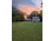 Large backyard with green lawn, privacy fence, shed, and mature shade trees at 1120 Seaside Ln, Charleston, SC 29412