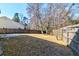 Expansive backyard area featuring a stone patio, lawn, and wood perimeter fence at 118 Willowbend Ln, Summerville, SC 29485