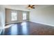 Bright bedroom features hardwood floors, ceiling fan, and two windows at 118 Willowbend Ln, Summerville, SC 29485