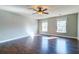 Bedroom with hardwood flooring, a ceiling fan, and two windows offering ample natural light at 118 Willowbend Ln, Summerville, SC 29485