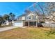 Side view of a two-story home featuring a well-kept lawn and a two-car garage at 118 Willowbend Ln, Summerville, SC 29485