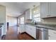 Updated kitchen featuring white cabinets, granite countertops, stainless steel appliances, and access to the living room at 118 Willowbend Ln, Summerville, SC 29485