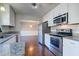 Remodeled kitchen with granite countertops, stainless steel appliances, white subway tile backsplash, and dark wood flooring at 118 Willowbend Ln, Summerville, SC 29485