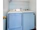 Modern laundry room with white, front-loading washer and dryer at 118 Willowbend Ln, Summerville, SC 29485