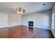 Bright living room with a fireplace, modern ceiling fan, and dark wood floors, perfect for cozy gatherings at 118 Willowbend Ln, Summerville, SC 29485