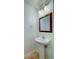 Updated powder room featuring a pedestal sink, decorative mirror, and modern lighting, adding style and convenience at 118 Willowbend Ln, Summerville, SC 29485