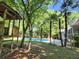 This backyard has a playhouse and pool, with palm trees that gives it a tropical feel at 130 Delaney Cir, Summerville, SC 29485