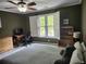 This bedroom includes light walls, a ceiling fan, and a window with white shutters at 130 Delaney Cir, Summerville, SC 29485