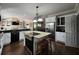 Spacious kitchen with white cabinetry, stainless steel appliances, and a kitchen island with bar stool seating at 130 Delaney Cir, Summerville, SC 29485