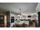 Bright kitchen area featuring white cabinetry, stainless steel appliances, and a cozy breakfast bar island with seating at 130 Delaney Cir, Summerville, SC 29485
