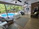 Enclosed back porch with ceiling fans and wicker furniture, offering views of the pool and yard at 130 Delaney Cir, Summerville, SC 29485