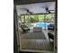 Relaxing screened porch overlooking a sparkling swimming pool and lush backyard greenery at 130 Delaney Cir, Summerville, SC 29485
