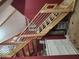 Wooden staircase with white railing leading upstairs, next to closet and dresser for storage at 130 Delaney Cir, Summerville, SC 29485