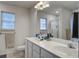 Bathroom featuring dual sinks, a large mirror, and a window for natural light at 1341 Belle Grove Cir, Hanahan, SC 29410