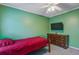 A bedroom with green walls, a ceiling fan, and a view of a flat screen television at 1341 Belle Grove Cir, Hanahan, SC 29410