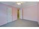 An empty bedroom with pink walls and carpeted floors, lit by a ceiling fan at 1341 Belle Grove Cir, Hanahan, SC 29410