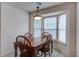 Dining area features a wooden table, four chairs, and a bay window for lots of light at 1341 Belle Grove Cir, Hanahan, SC 29410