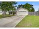 Charming single-story home featuring a manicured lawn, mature trees, and an attached two-car garage at 1341 Belle Grove Cir, Hanahan, SC 29410